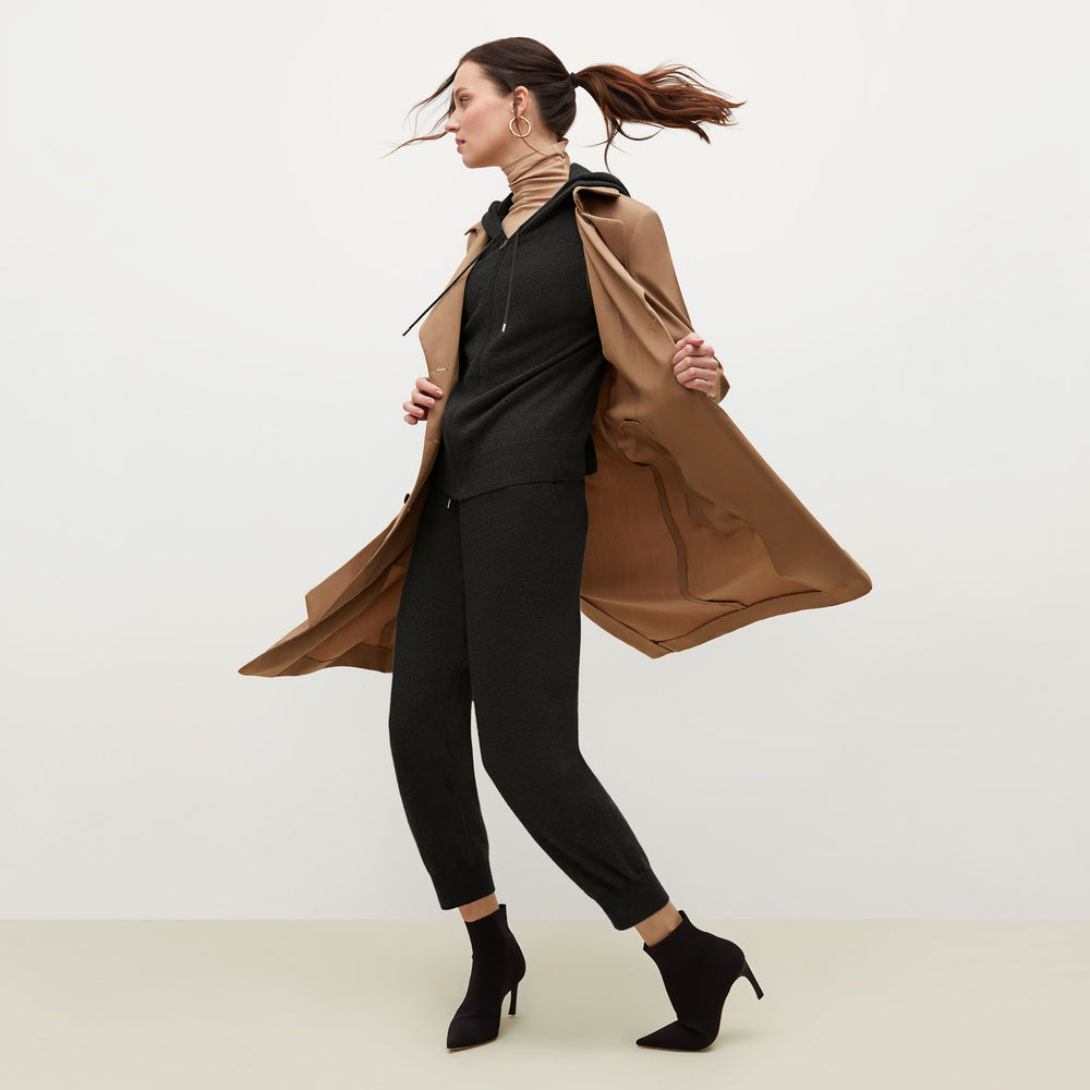 Side image of a woman standing wearing the Judith Hoodie—Cashmere in Black