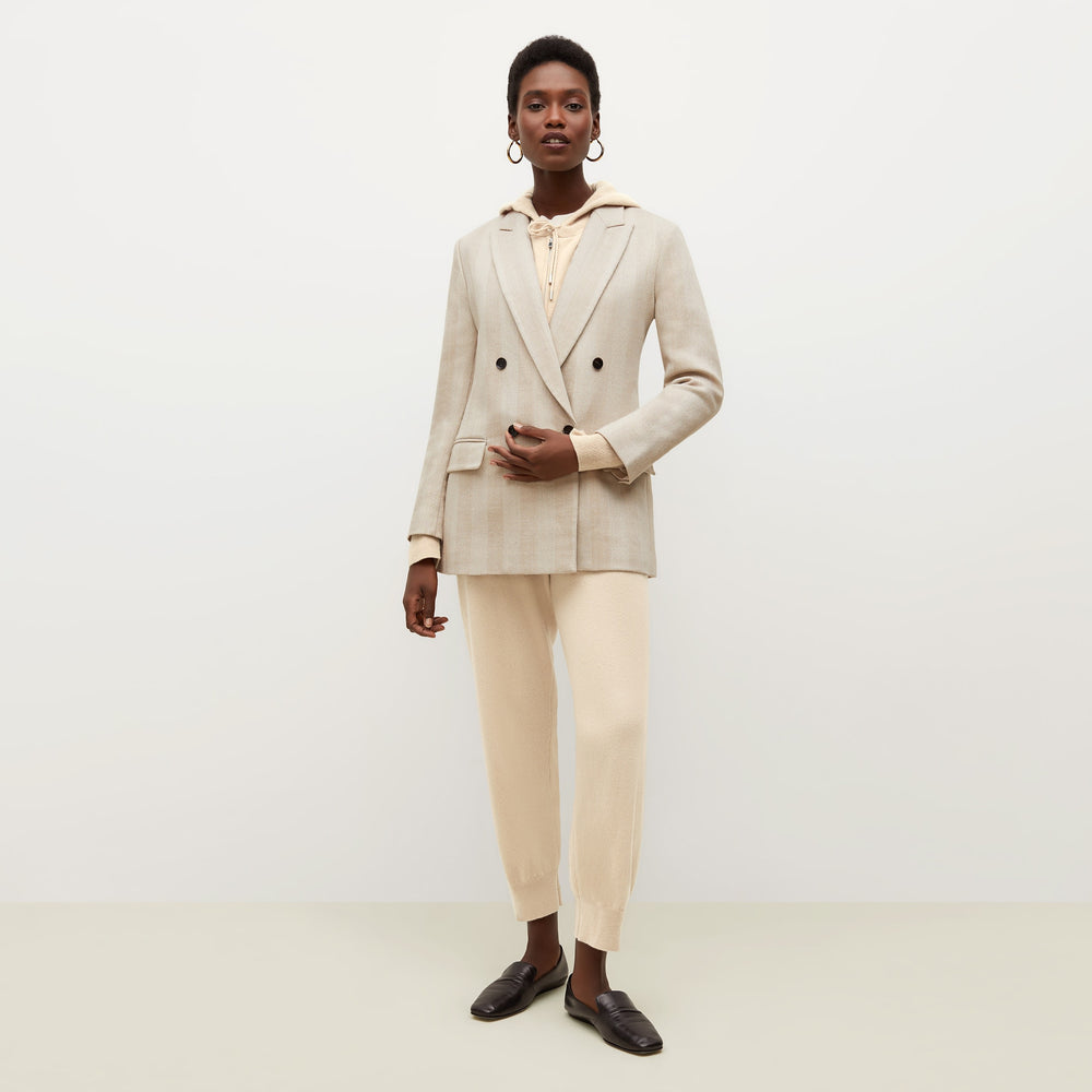 Front image of a woman standing wearing the Judith Hoodie—Cashmere in Turbinado