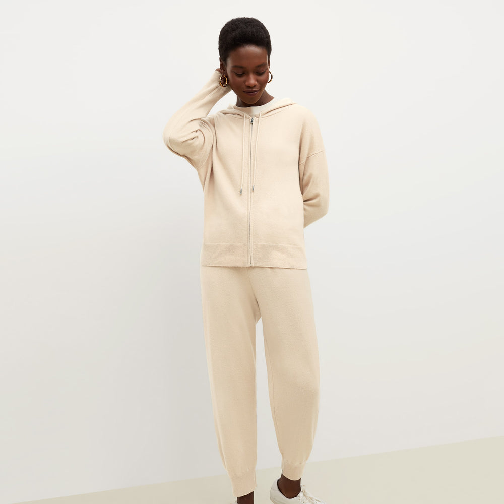 Front image of a woman standing wearing the Judith Hoodie—Cashmere in Turbinado