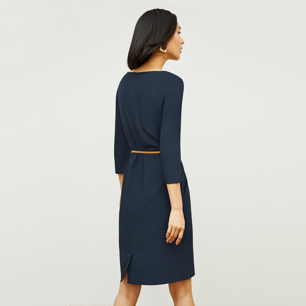 Back image of a woman standing wearing the Etsuko Dress—Recycled WonderTex in Midnight
