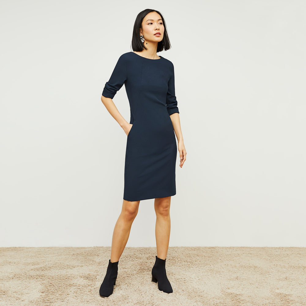 Front image of a woman standing wearing the Etsuko Dress—Recycled WonderTex in Midnight