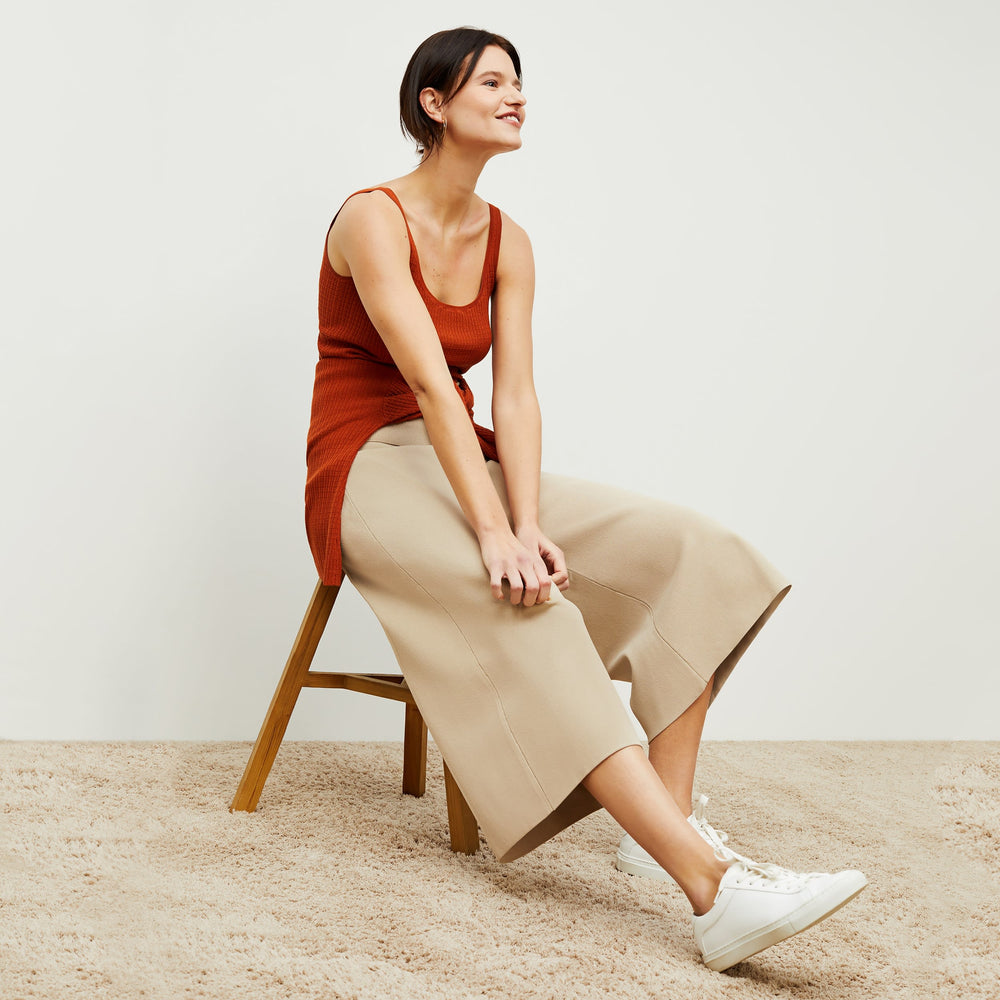 Side image of a woman standing wearing the rogala culotte in latte