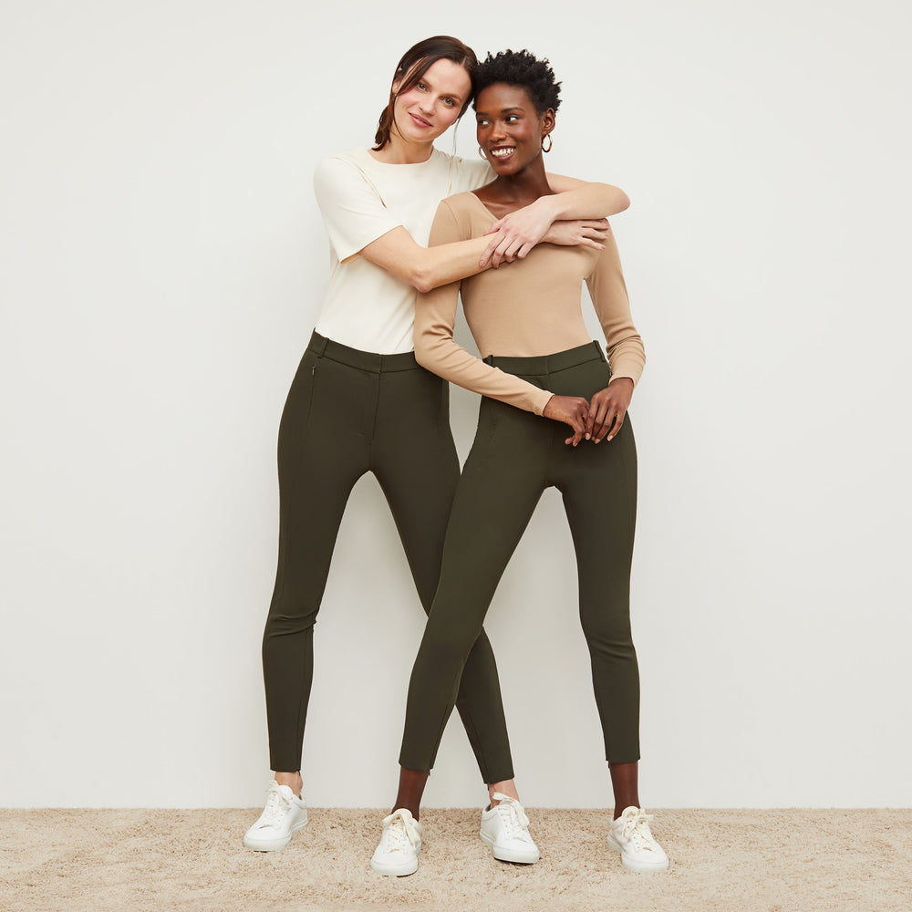 Front image of a woman standing wearing the curie pant in dark olive