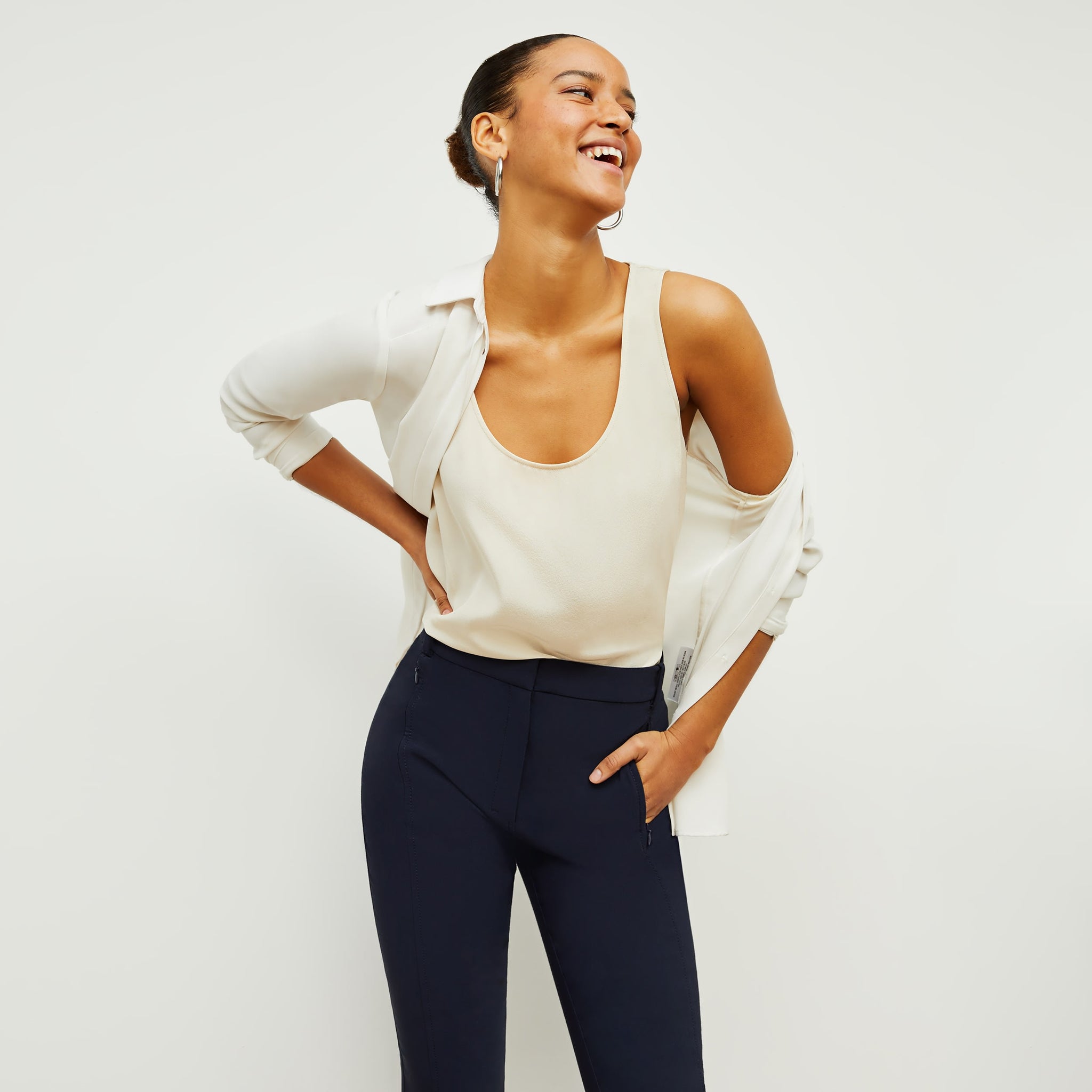 Front image of a woman standing wearing the curie pant in dark navy