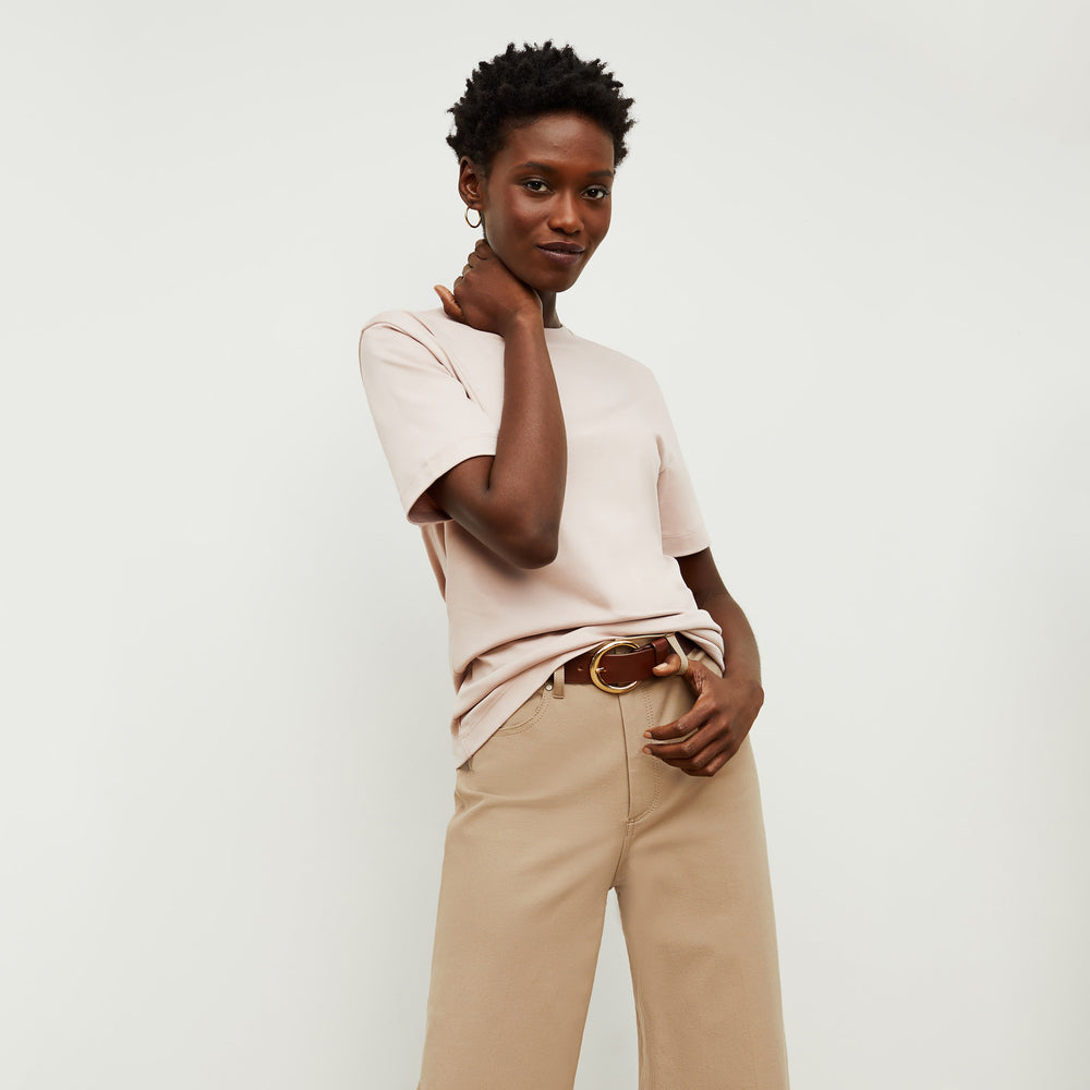 Front image of a woman standing wearing the Leslie T-Shirt—Compact Cotton in Dusty Pink