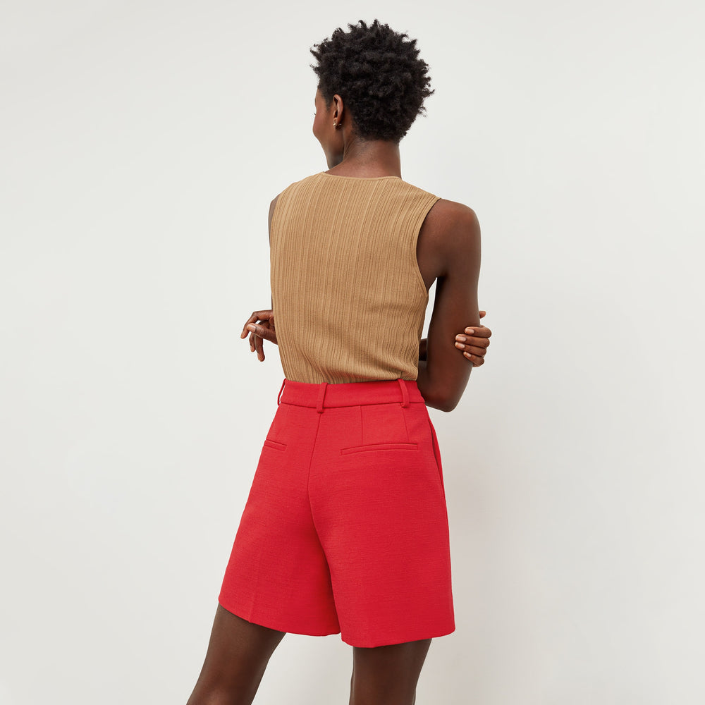 Back image of a woman standing wearing the Fletcher Short—Nep Suiting in Poppy