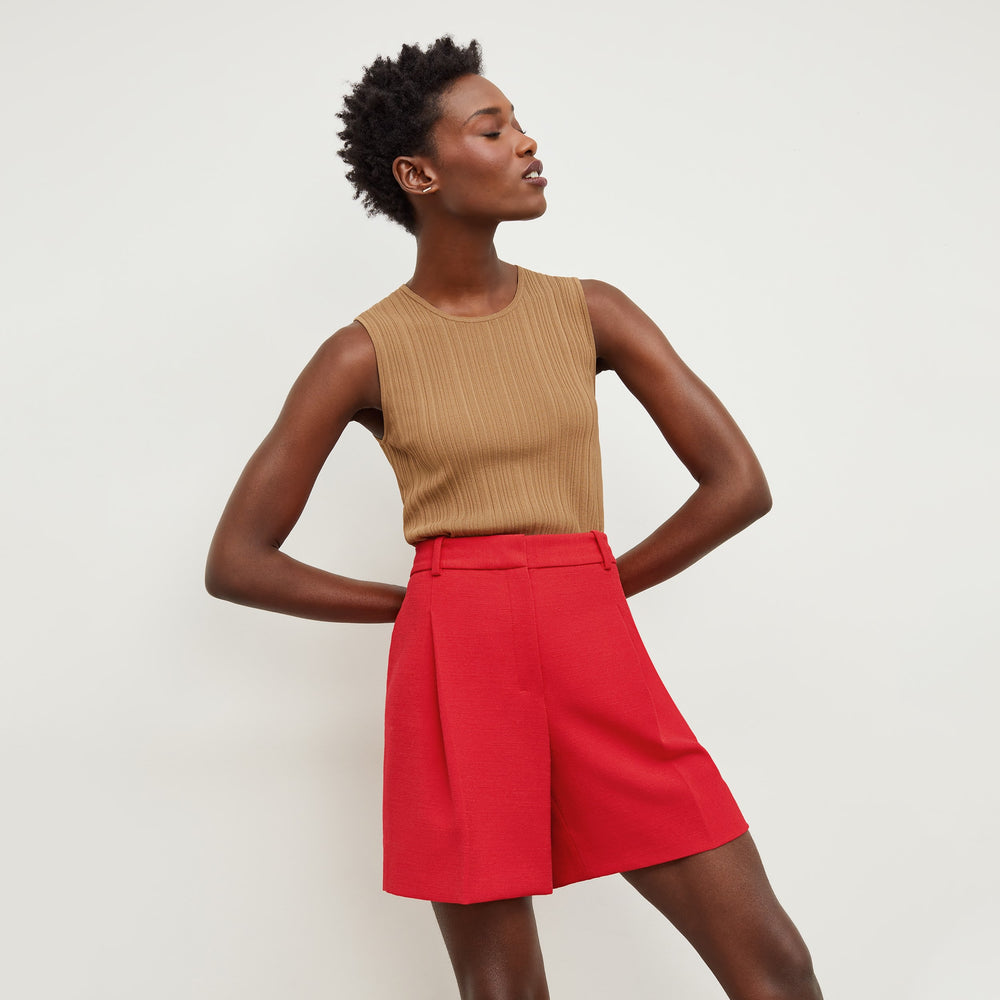 Front image of a woman standing wearing the Louisa Top in Sandstone