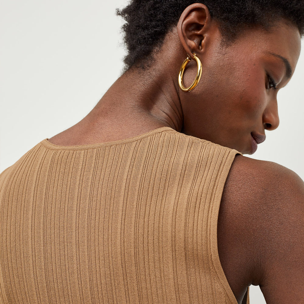 Detail image of a woman standing wearing the Louisa Top in Sandstone