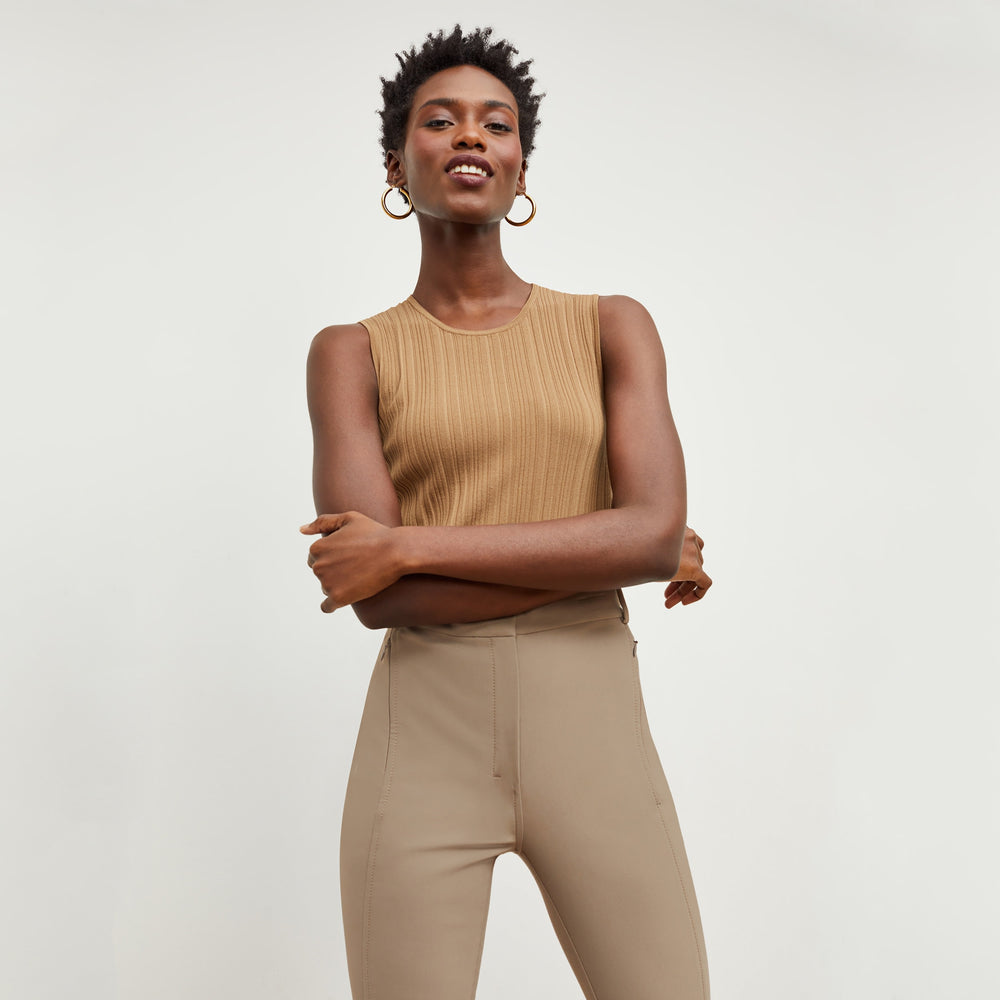 Front image of a woman standing wearing the Louisa Top in Sandstone