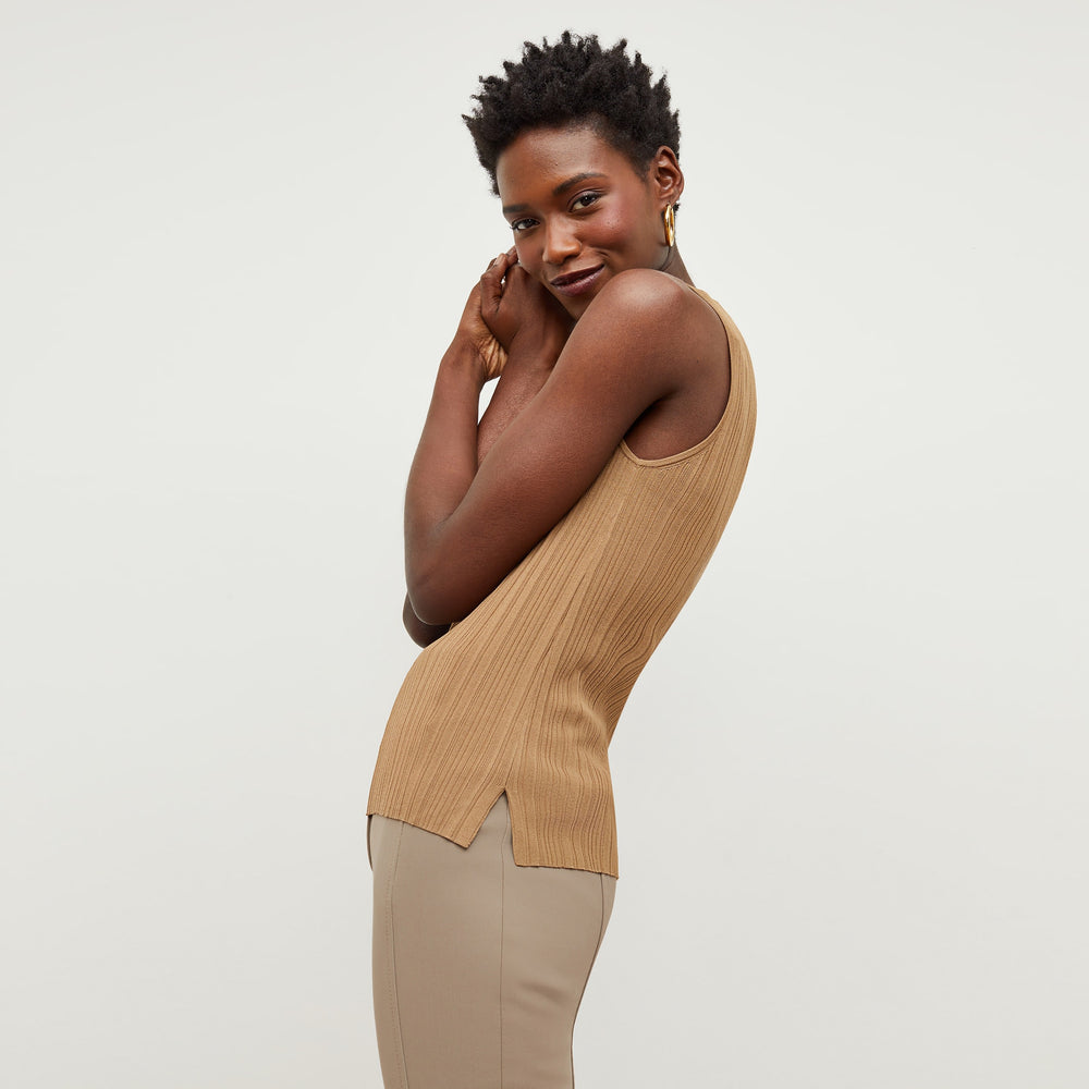 Side image of a woman standing wearing the Louisa Top in Sandstone