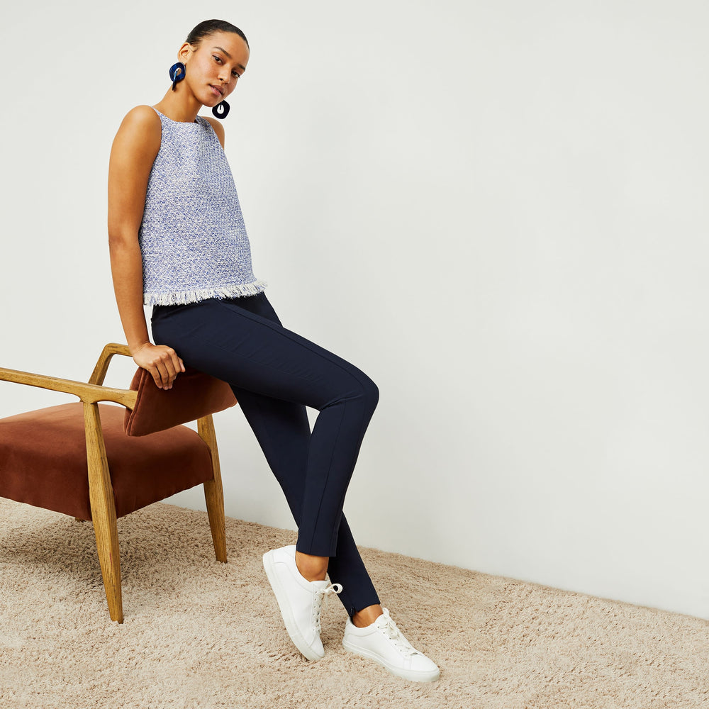 Front image of a woman standing wearing the flaka top in cotton boucle in lapis / ivory