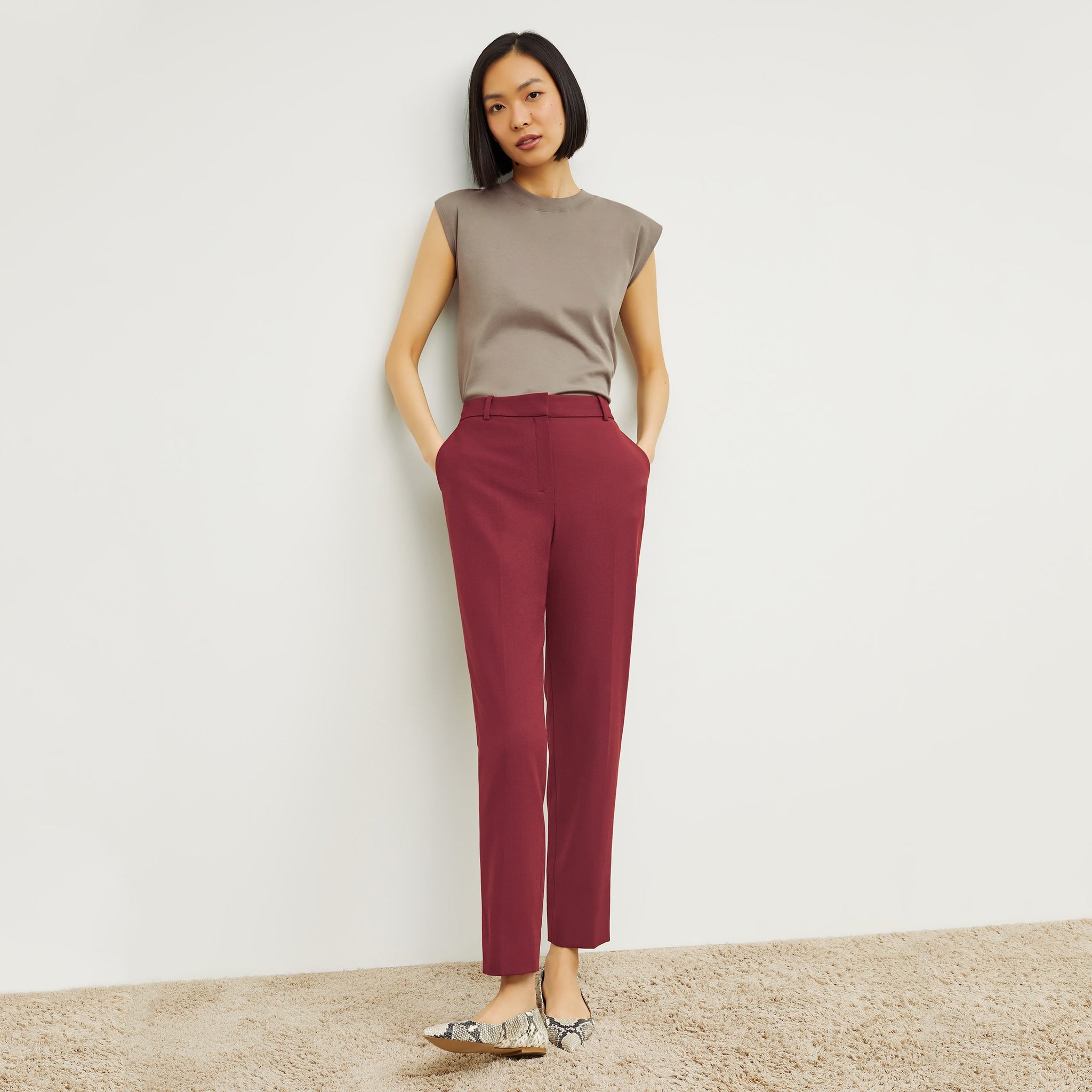 Front image of a woman standing wearing the Alina T-Shirt—Compact Cotton in Pebble