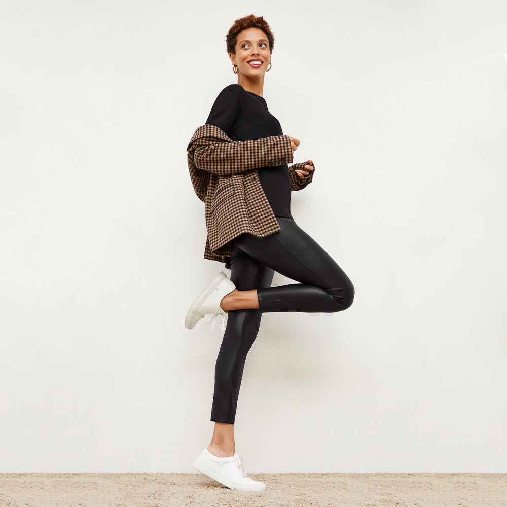 Side image of a woman wearing the Owen T-Shirt in Black