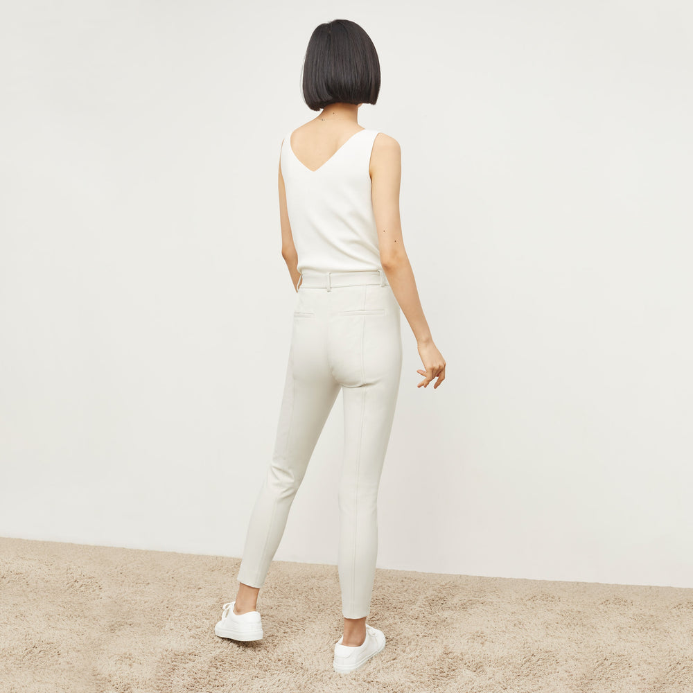 Back image of a woman standing wearing the Curie Pant—Everstretch in Bone