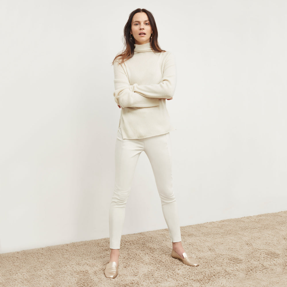 Front image of a woman standing wearing the Curie Pant—Everstretch in Bone
