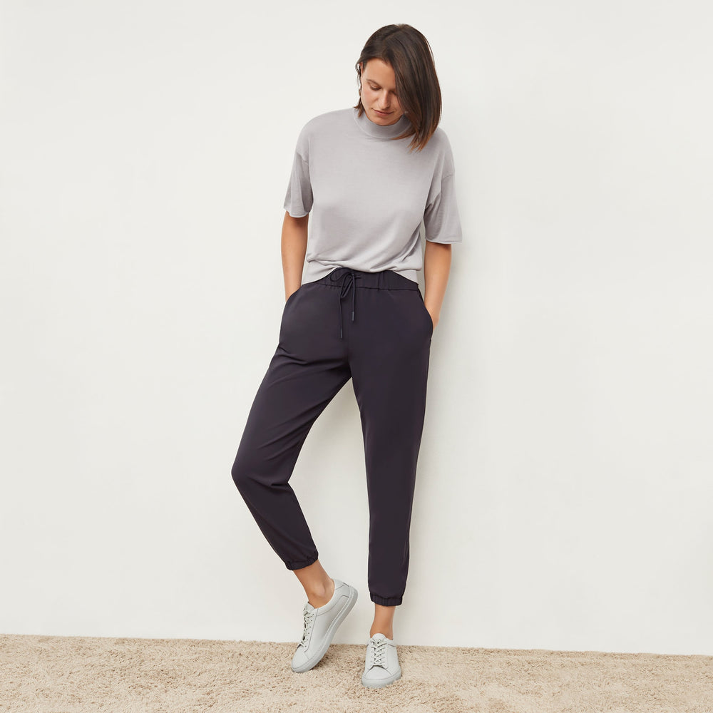 Front image of a woman standing wearing the mia top in silk jersey in pale gray