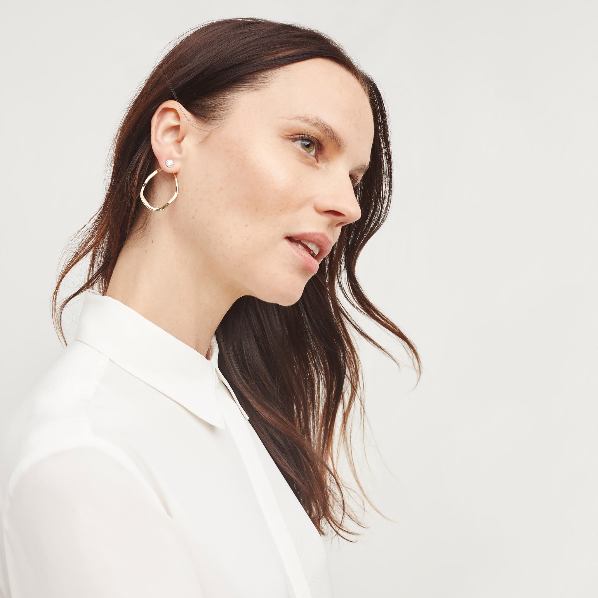 Front image of a woman wearing the tatum shirt in ivory