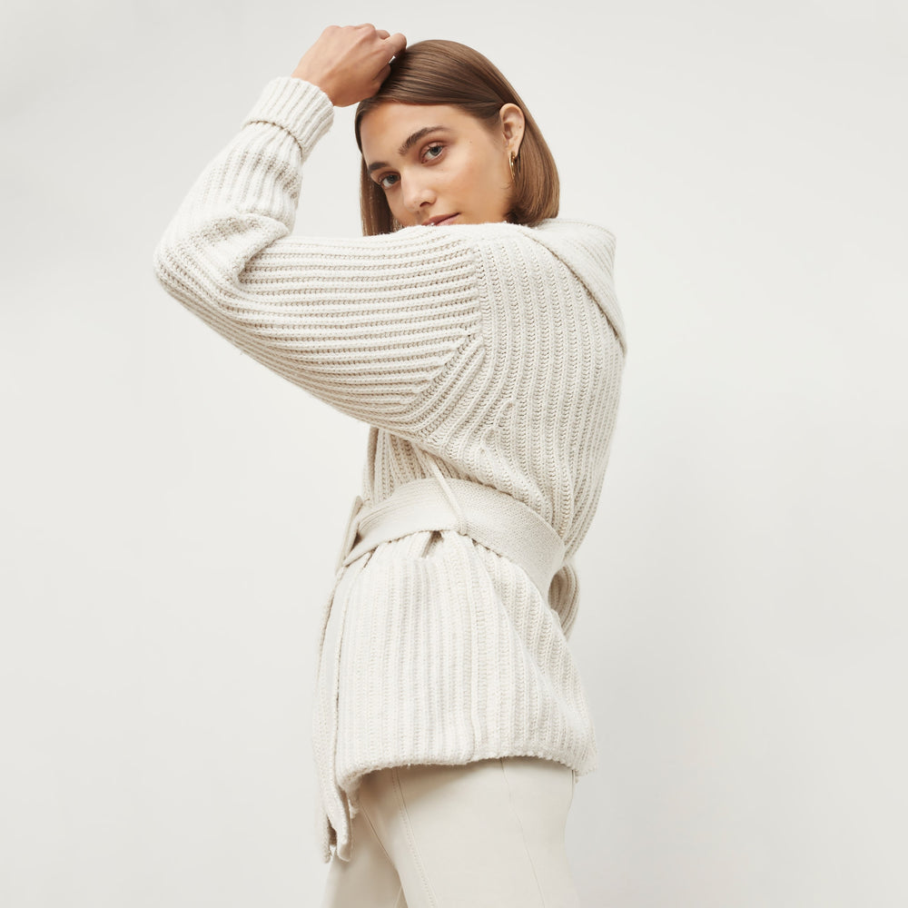 Side image of a woman standing wearing the Snyder Jacket in Ivory
