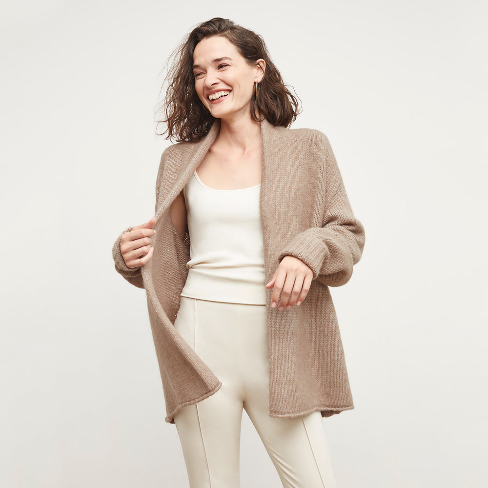 Front image of a woman standing wearing the Frederick Cardigan in Dark Taupe