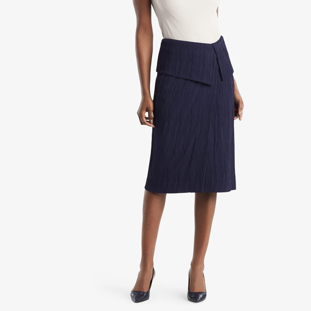 Front image of a woman standing wearing the Montgomery Skirt in aegean blue