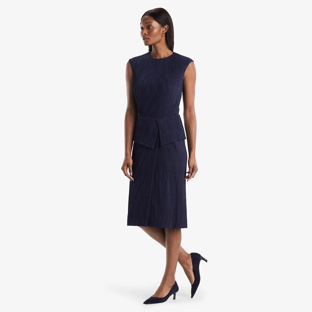 Hero image of a woman standing wearing the Montgomery Skirt in aegean blue