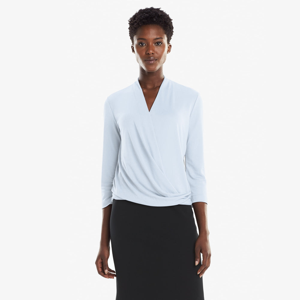 Front image of a woman standing wearing the Deneuve top in Oxford Blue