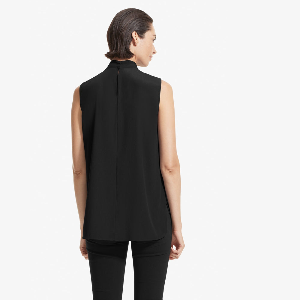 Back image of a woman standing wearing the Beverly top soft wave in Black