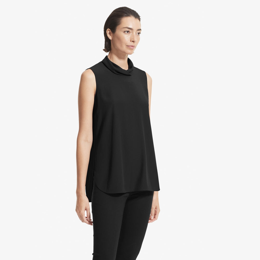 Side image of a woman standing wearing the Beverly top soft wave in Black
