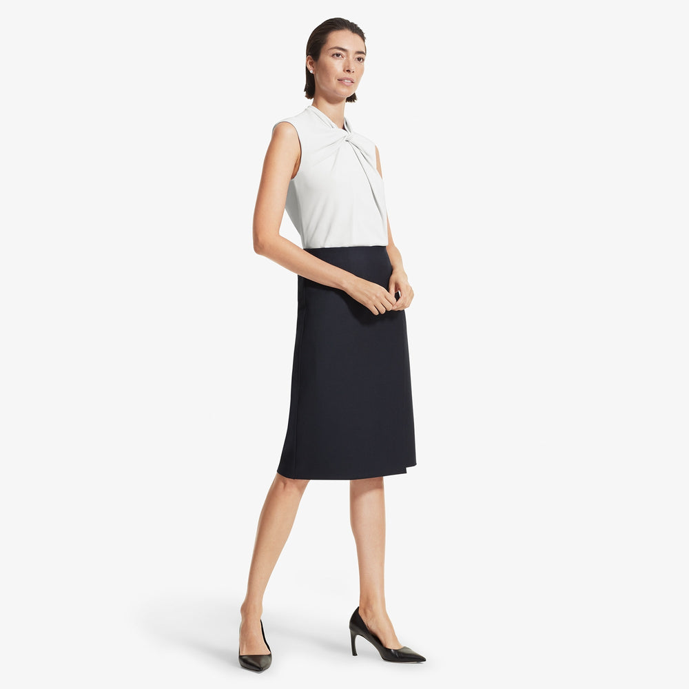 Front image of a woman standing wearing the Walters top knit crepe in Ivory