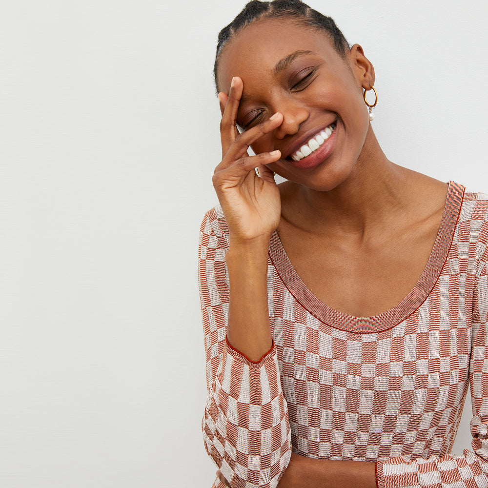 Detail image of a woman wearing the Tippy Dress - Checkered Knit in Red Clay / Natural
