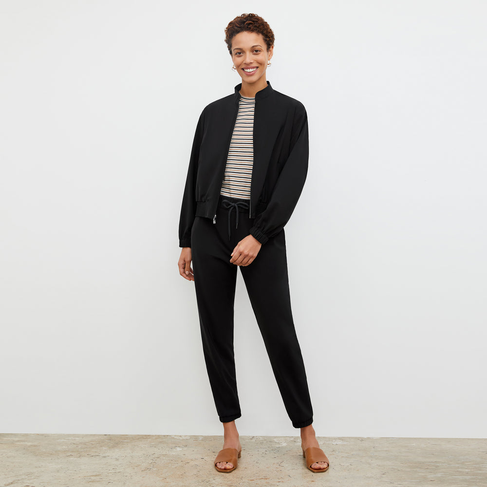 Front image of a woman wearing the Leslie T-Shirt - Thin Striped Pima Cotton in Tan / Black