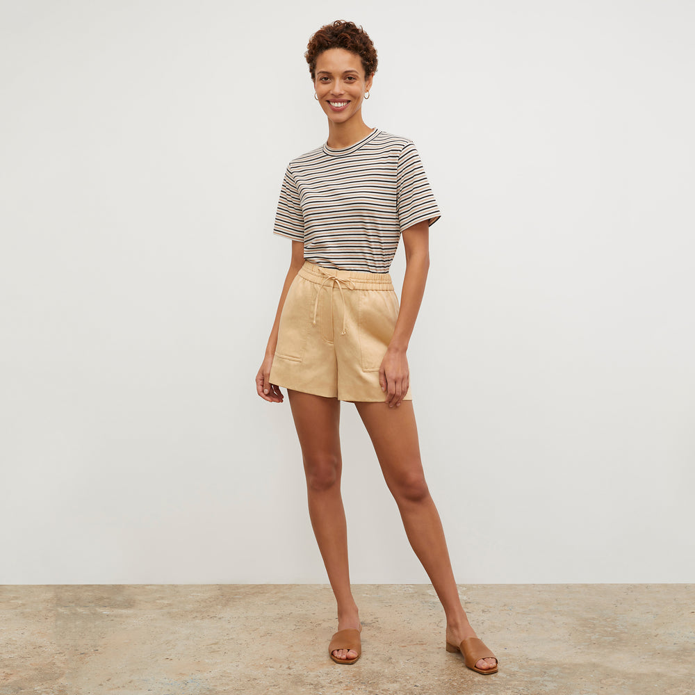 Front image of a woman wearing the Leslie T-Shirt - Thin Striped Pima Cotton in Tan / Black