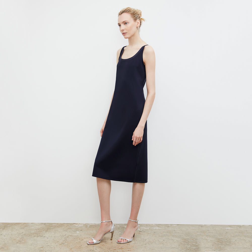 Side image of a woman wearing the Elsa Dress - Light Scuba in Space Blue