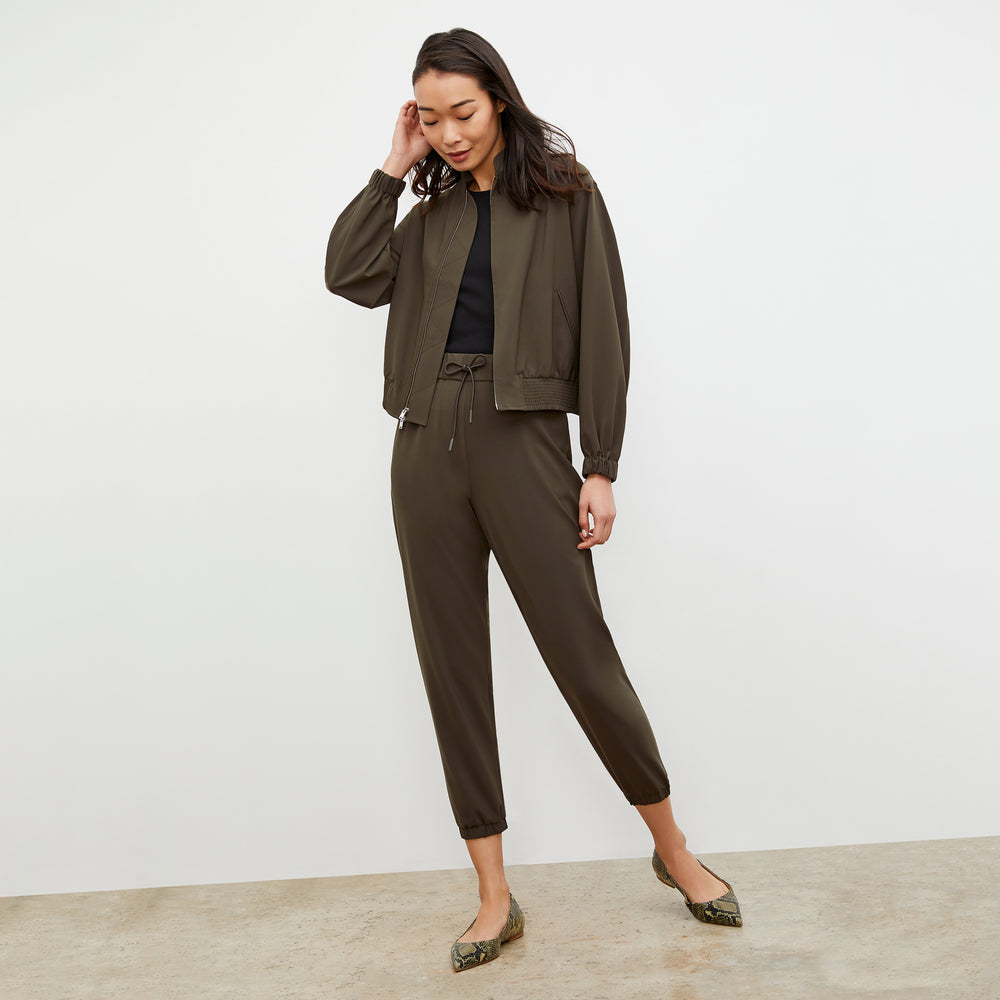 Front image of a woman wearing the Langley Bomber - OrigamiTech in Olive