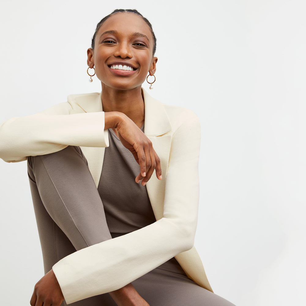 Front image of a woman wearing the Stella legging in Pebble