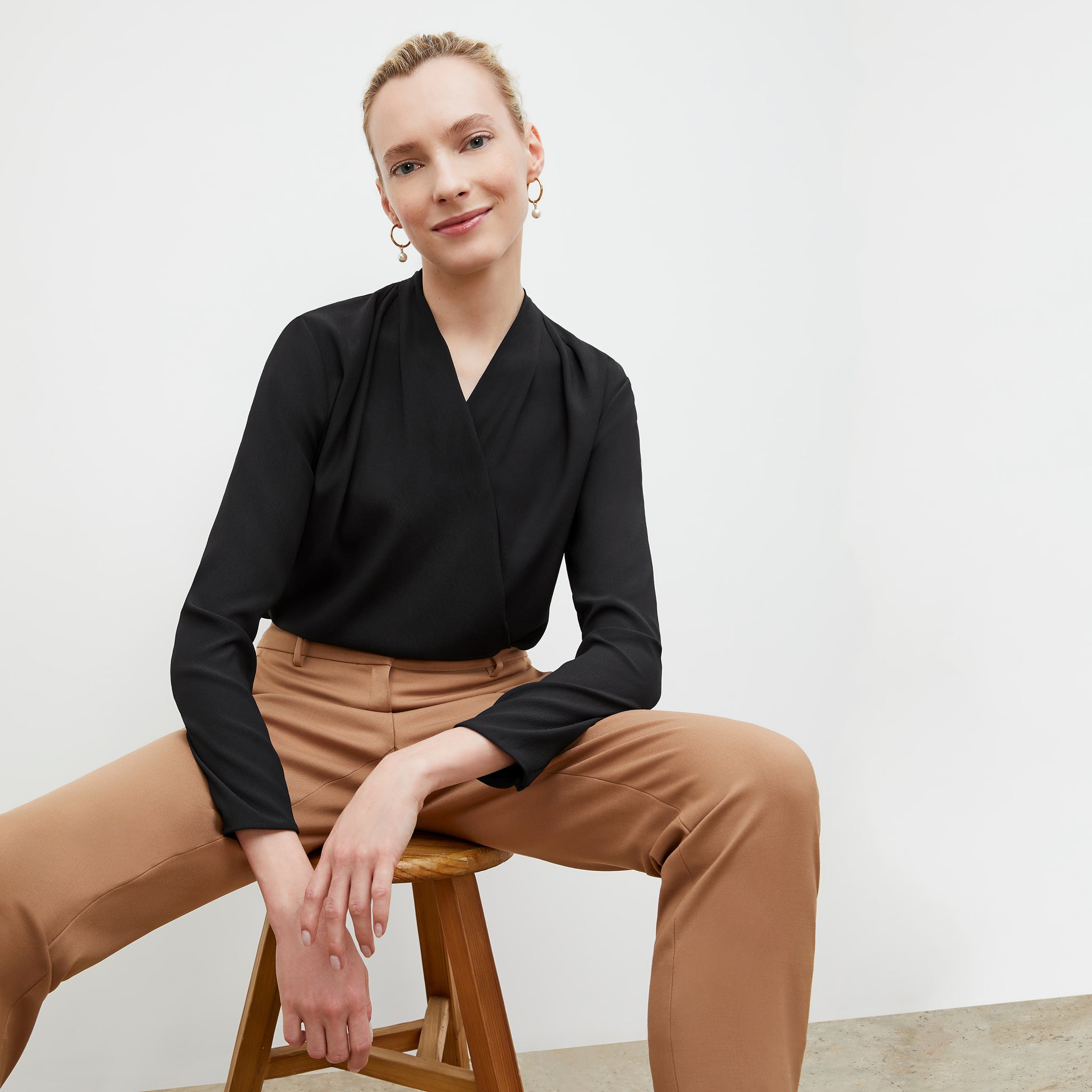 Front image of a woman wearing the antoinette top in black 