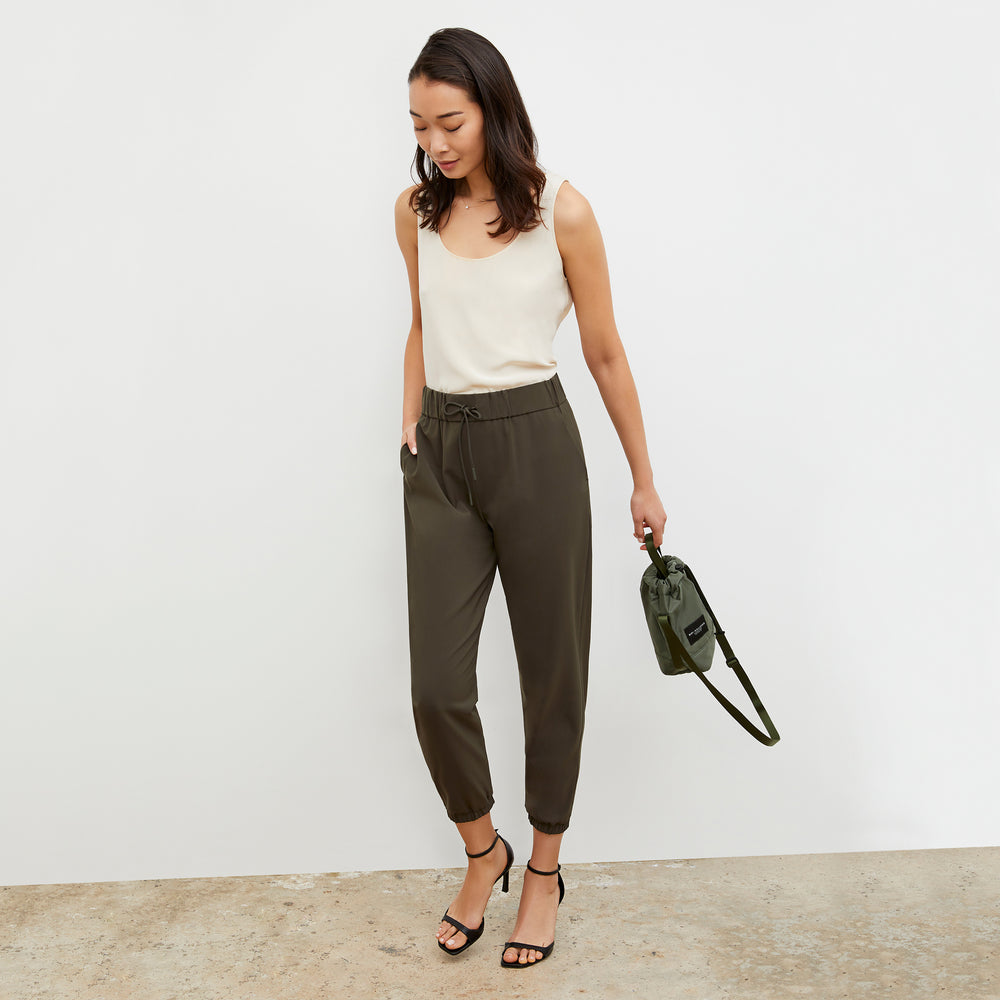 Front image of a woman wearing the Bags in Progress x MM Padded Mini Bucket Bag in Khaki Green