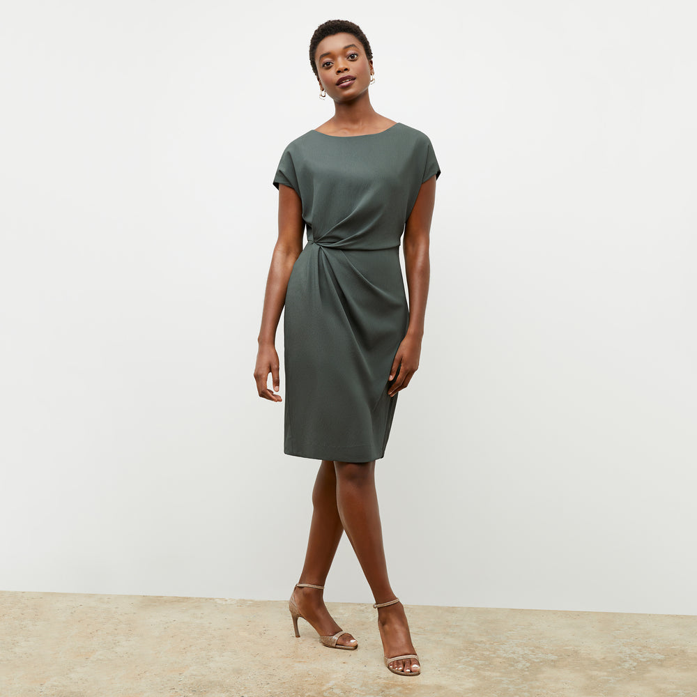 Front image of a woman wearing the jillian dress in aloe