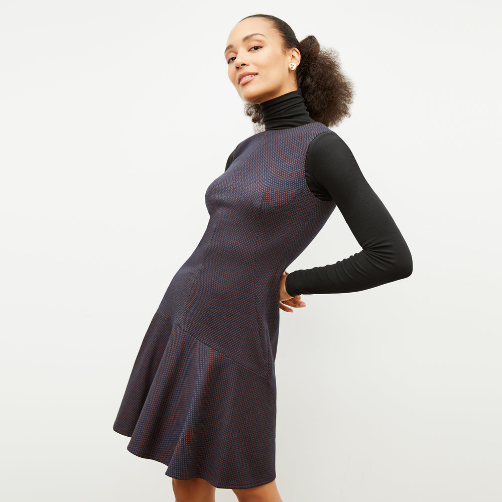 Front image of a woman wearing the jayde dress in navy multi