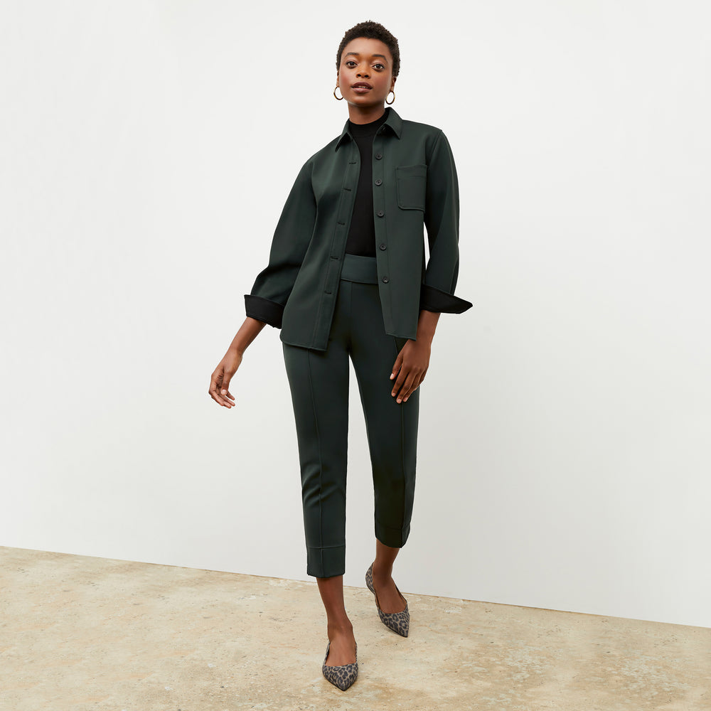 Front image of a woman wearing the robin pant in forest
