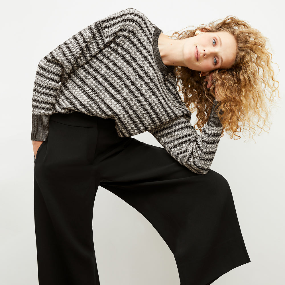 Front image of a woman wearing the tyler sweatshirt in black and white