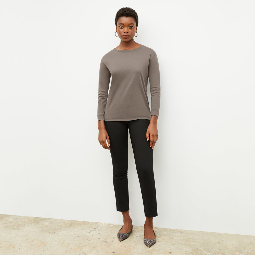 Front image of a woman wearing the owen t shirt in pebble