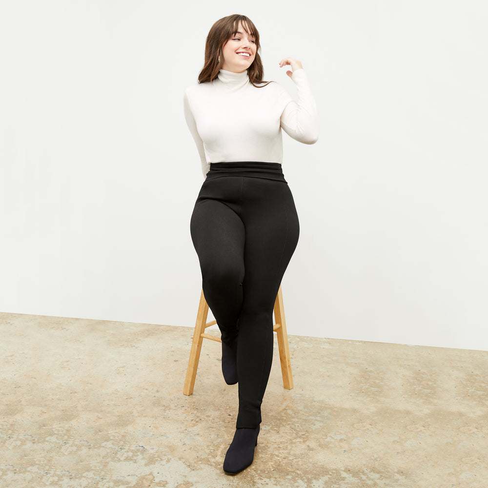 Front image of a woman standing wearing the stella legging in black