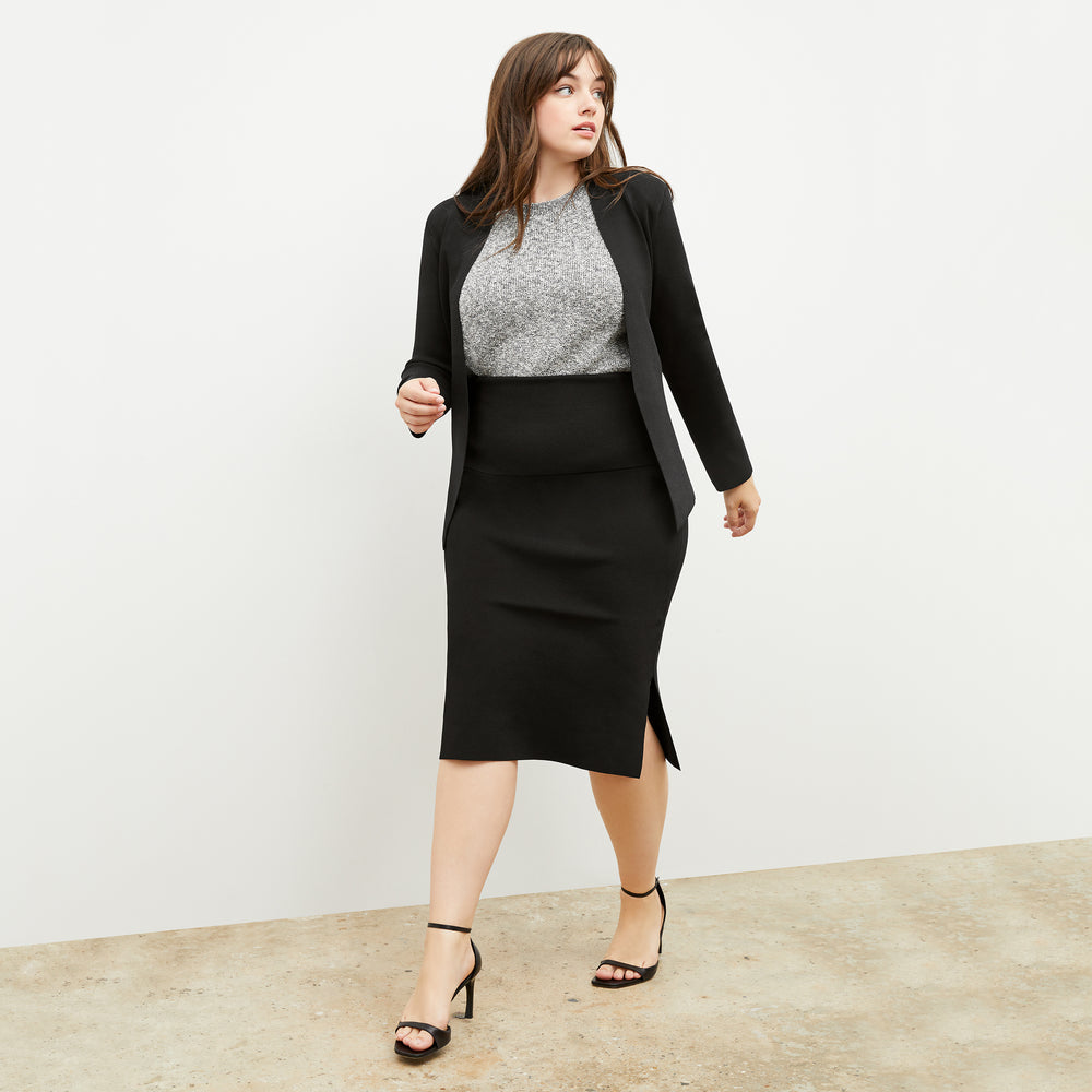 Front image of a woman standing wearing the Barbara Sweater—Knit Boucle in Black / White