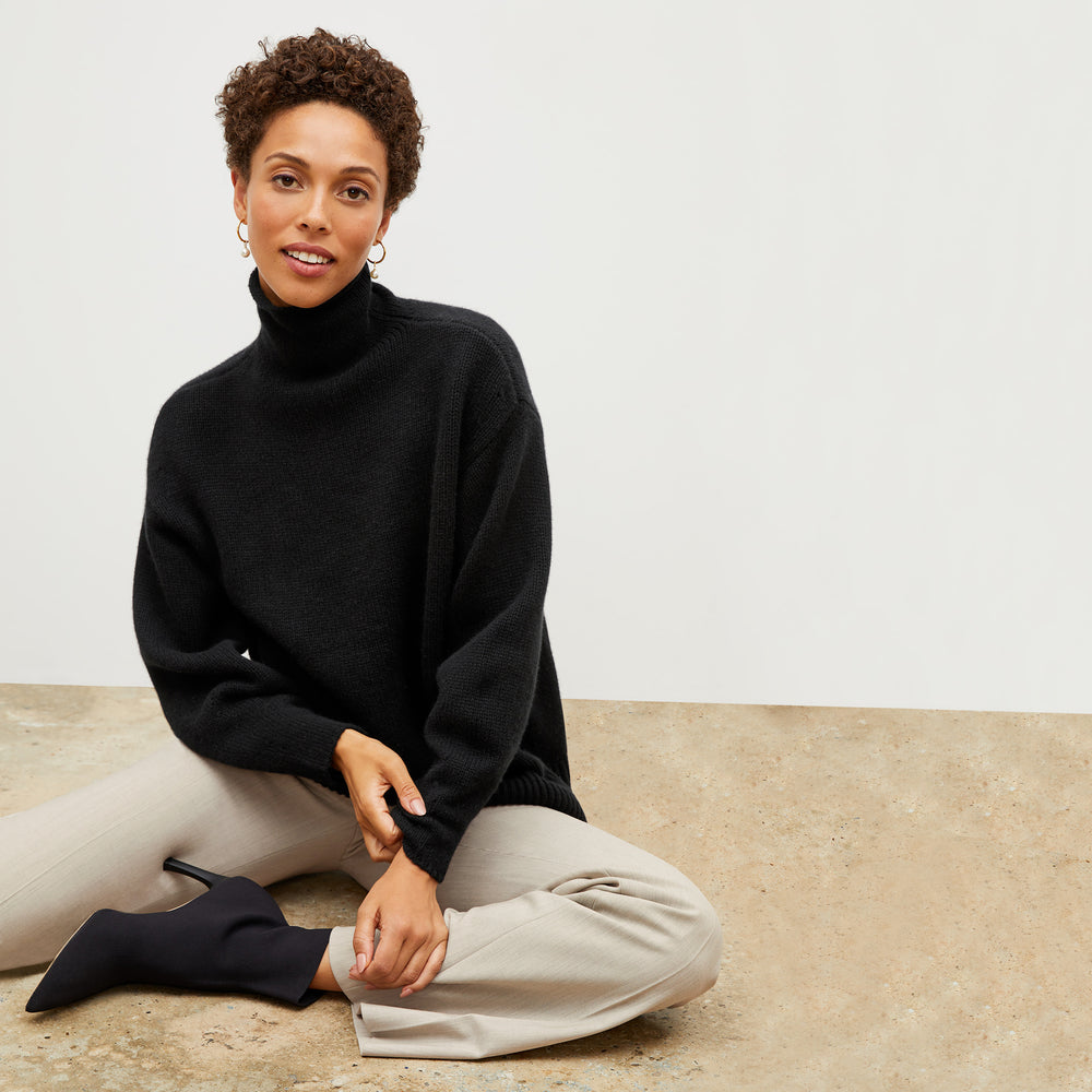 Front image of a woman wearing the lea sweater in black