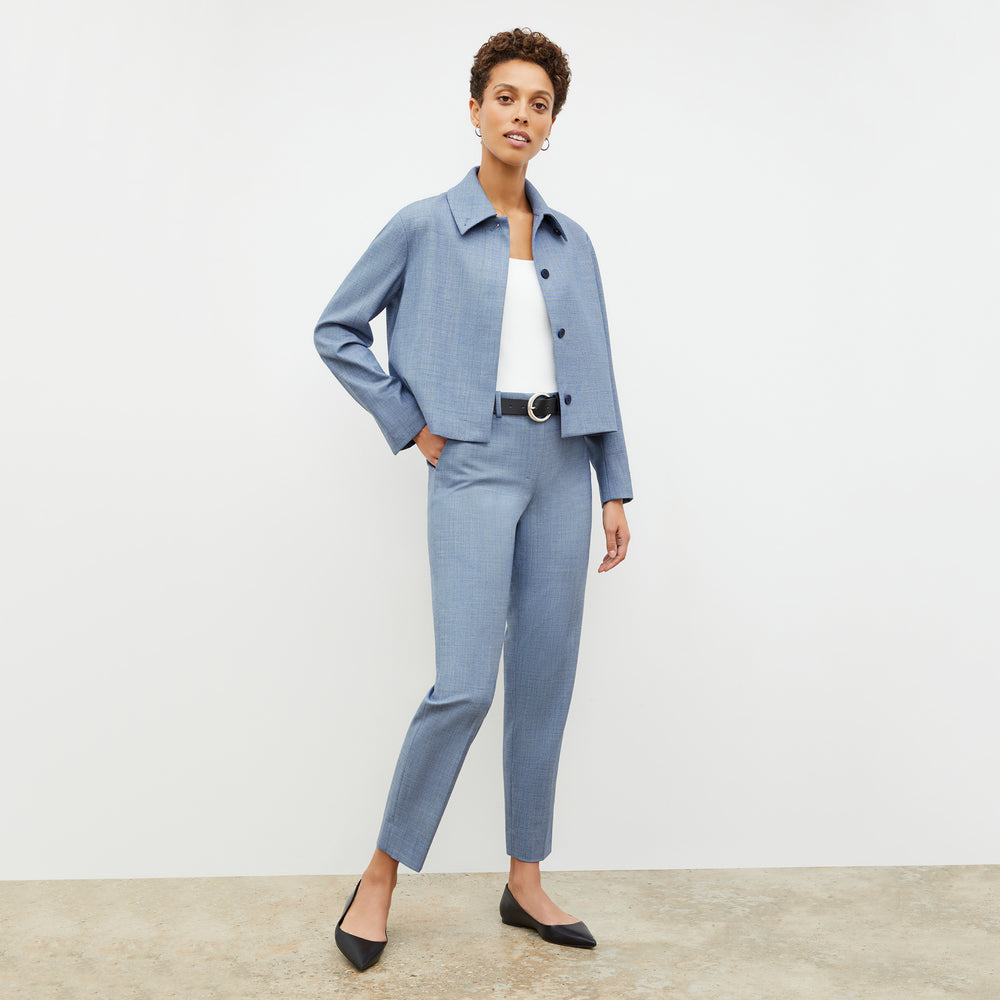 Front image of a woman wearing the nicky jacket in indigo and white