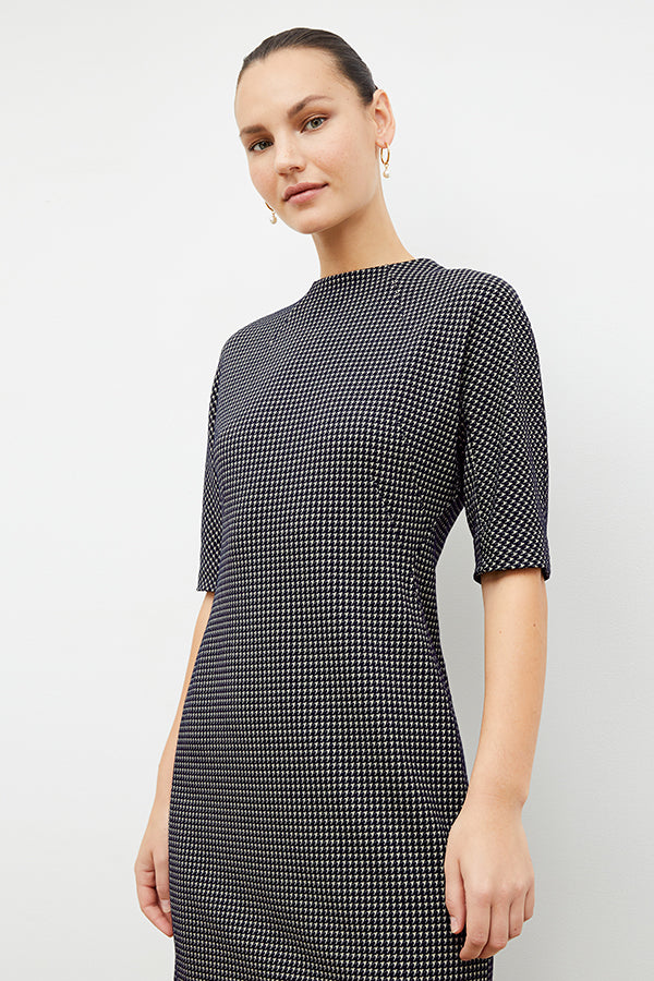 Front image of a woman wearing the farnoosh dress in black and white houndstooth