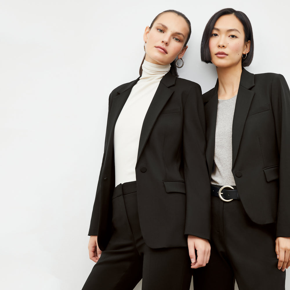 Front image of a woman wearing the Yiyan Blazer Short in Black and a woman wearing the Yiyan Blazer in Black