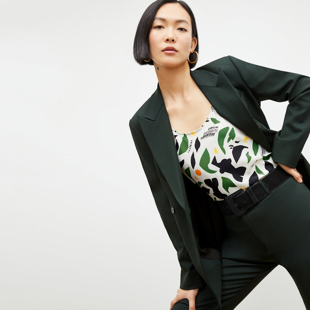 Front image of a woman wearing the kati jacket in forest