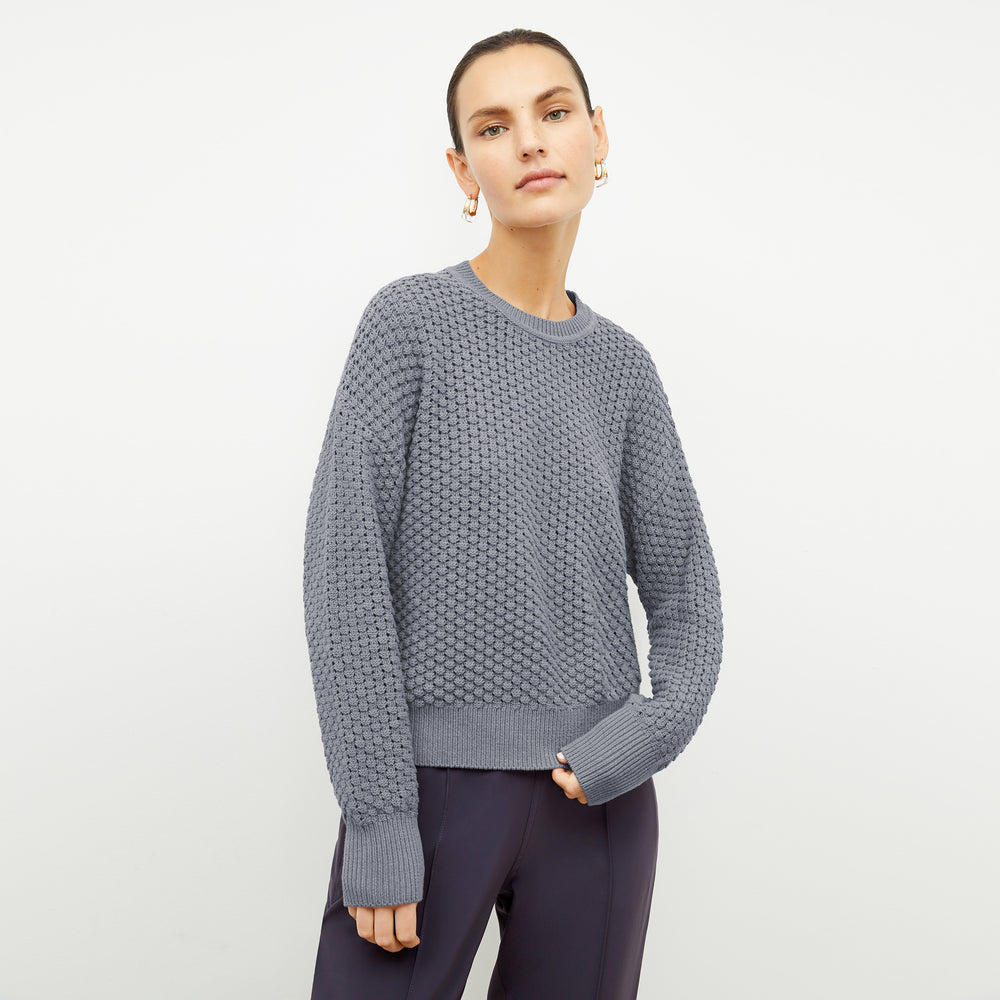 front image of a woman wearing the liam sweater in flint gray